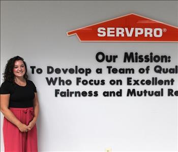 woman in front of mission statement