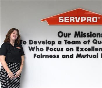 woman in front of mission statement