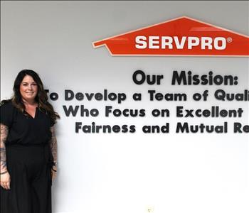 woman in front of mission statement